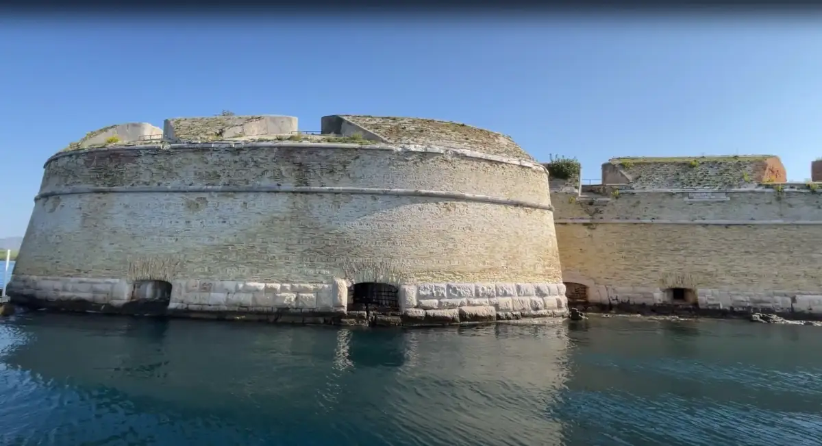 The robust walls of St. Nicholas Fortress in Šibenik, jutting out into the calm waters of the Adriatic Sea on a sunny day.